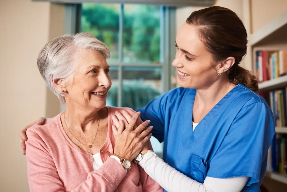 Caregiver with a resident in a warm home setting
